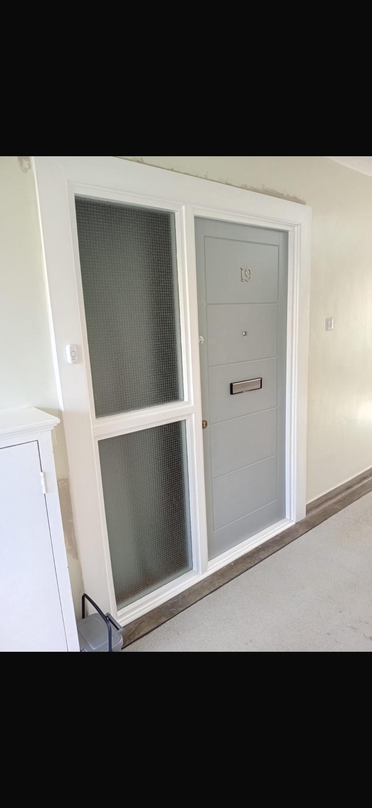 Bespoke fire door unit 19 installation with bare timber frame and glazed sidelight