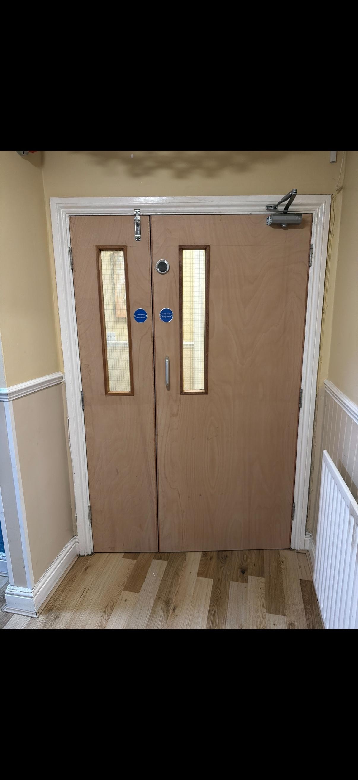Double wooden glazed fire doors with glass panels
