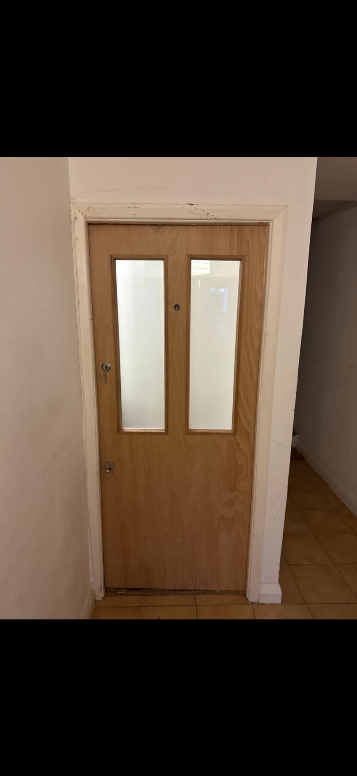 Wooden fire door with frosted glass panels