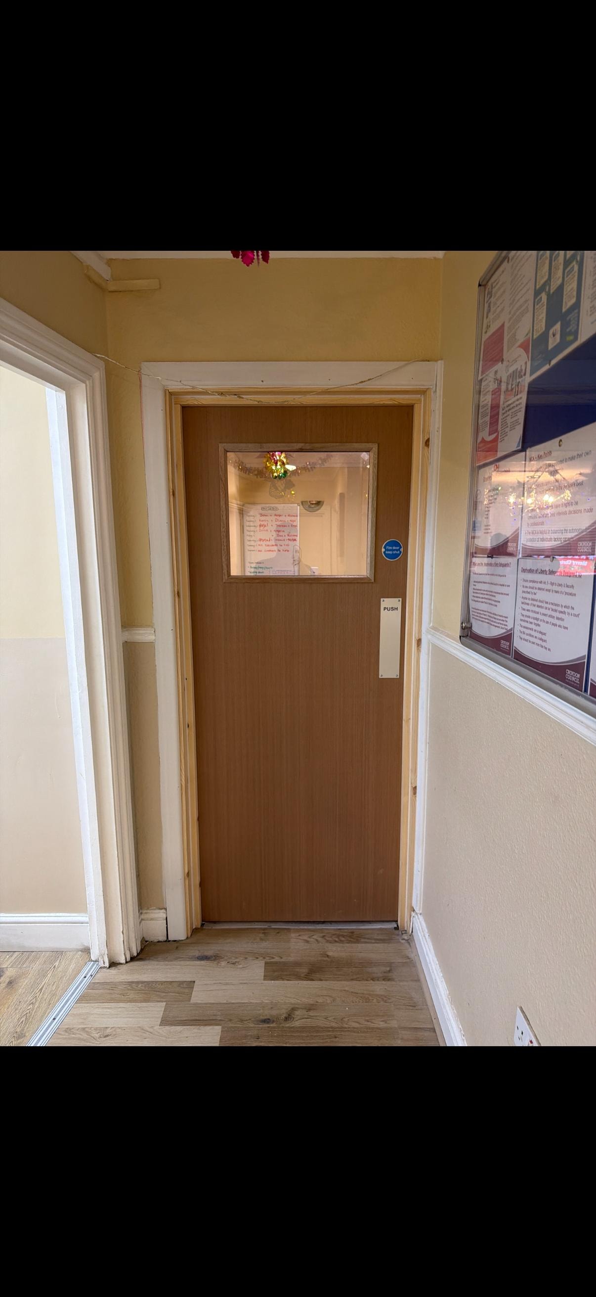 Brown wooden glazed fire door office hallway