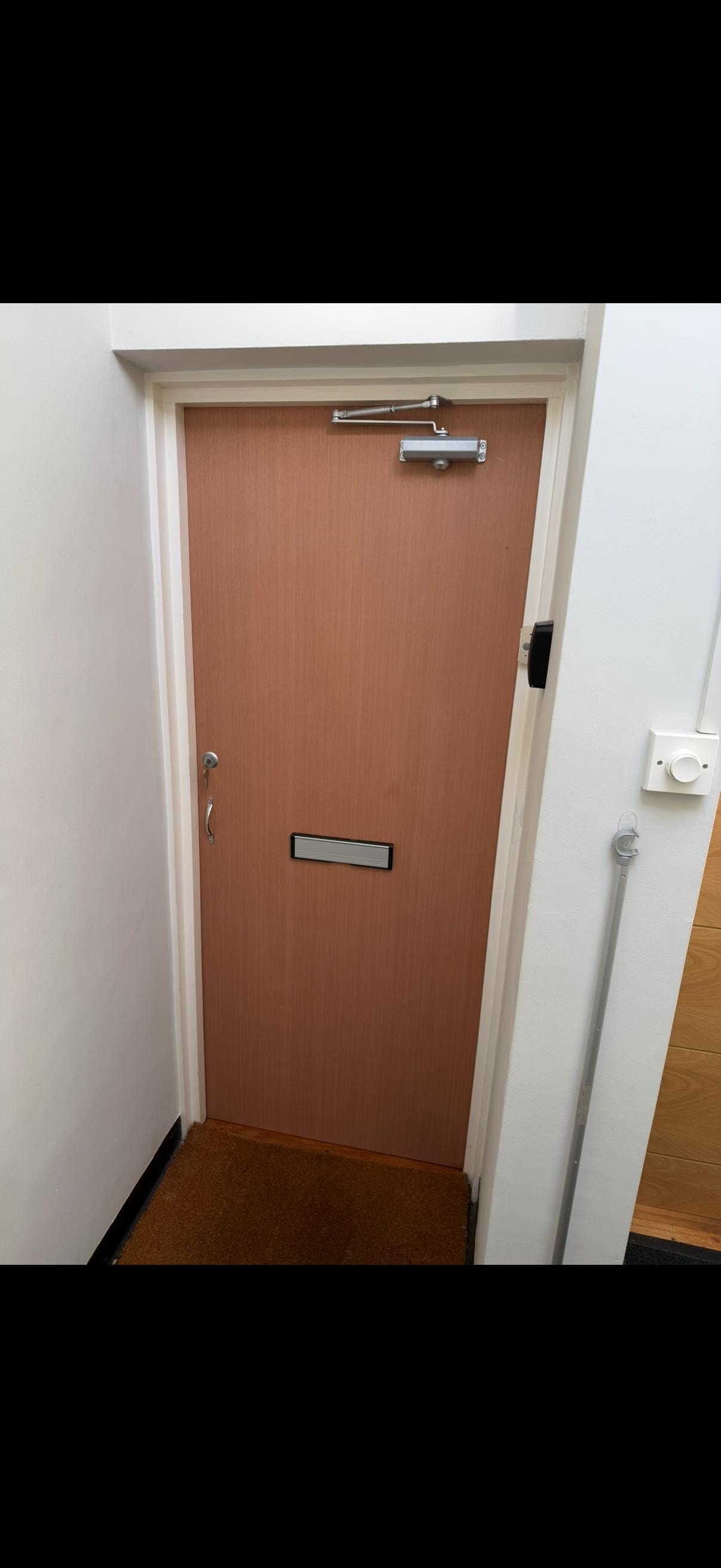 Brown apartment fire door with hardware