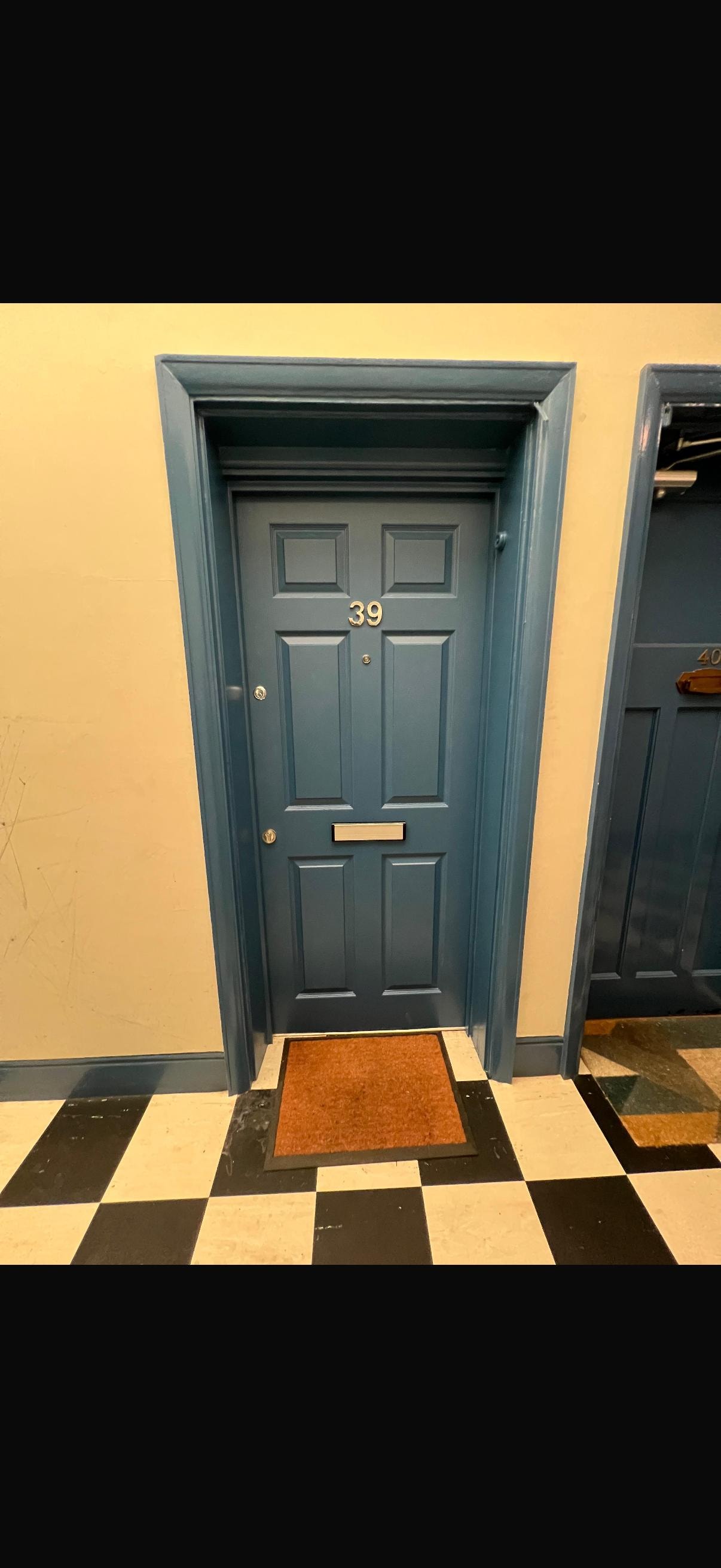 Blue fire door number 39 yellow wall