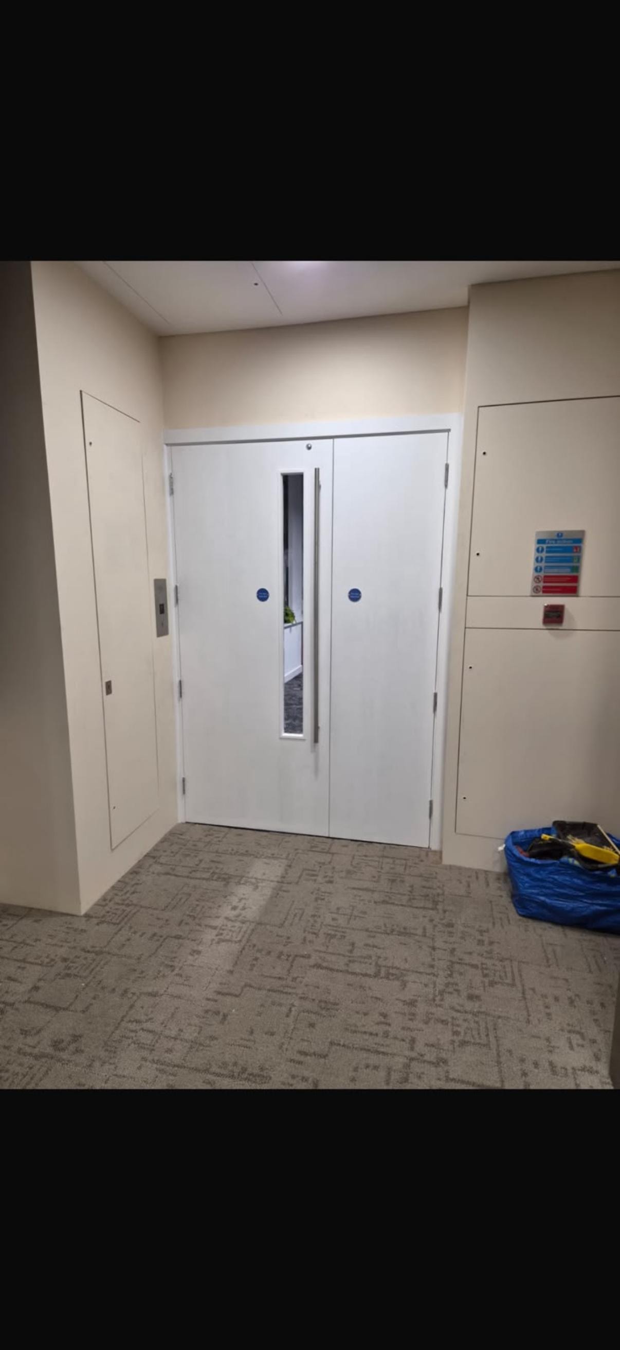 Modern office hallway with white glazed fire doors