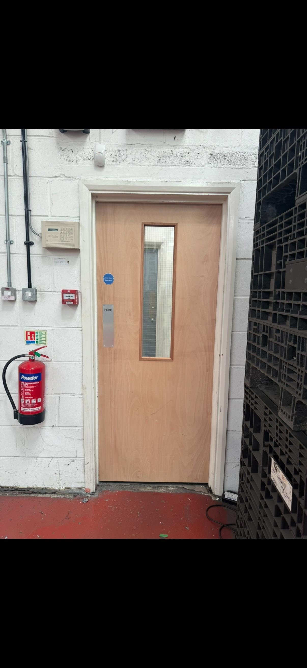 Wooden glazed fire door industrial building entrance