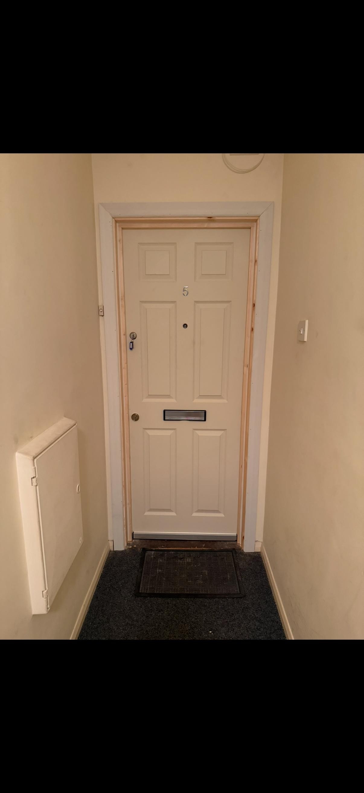 Apartment entryway with cream fire door