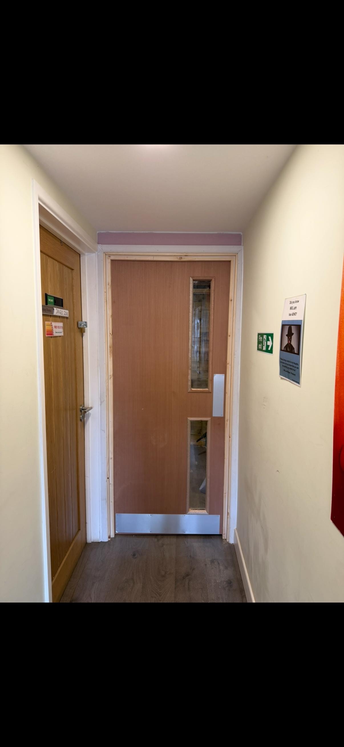 Narrow hallway with wooden glazed doors