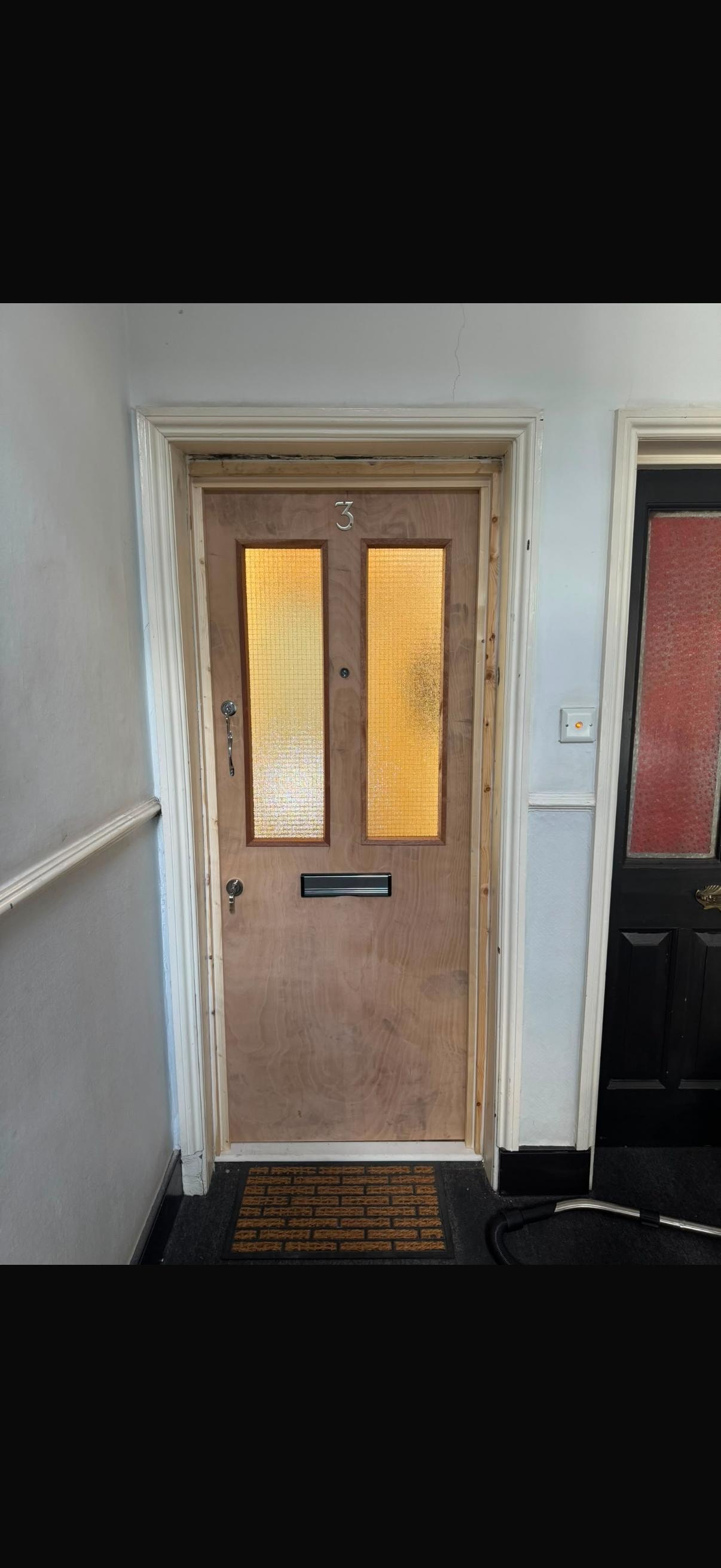 Wooden front door with yellow glass panels