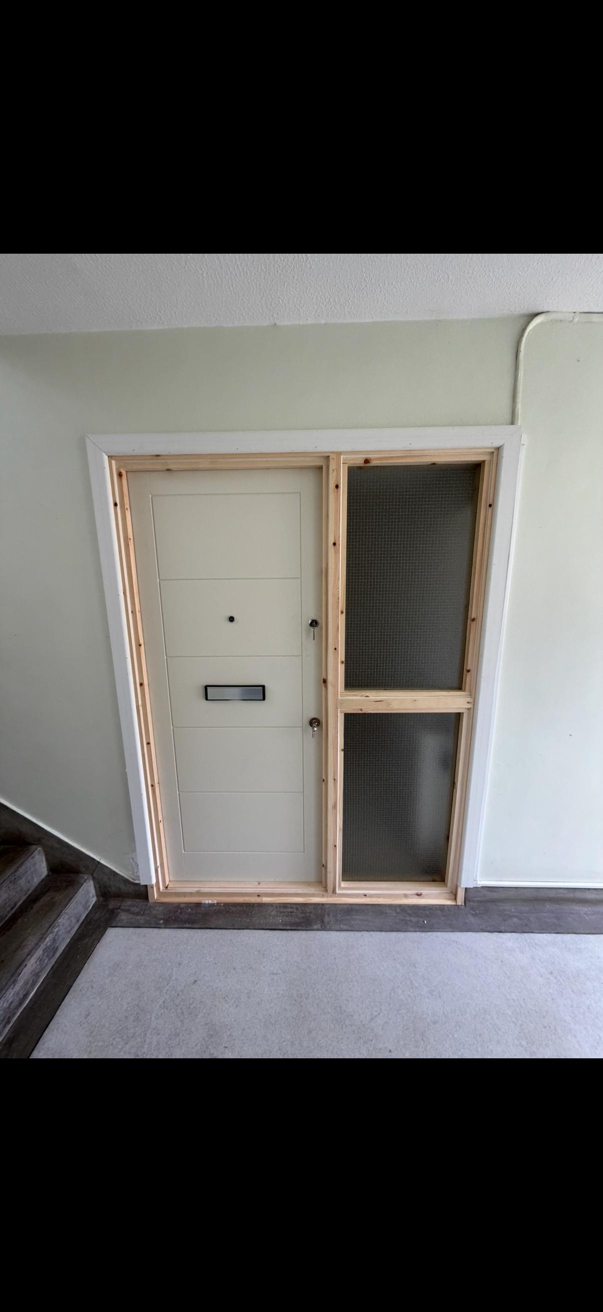 Bespoke fire door unit 19 mid-installation with pink glazed sidelight