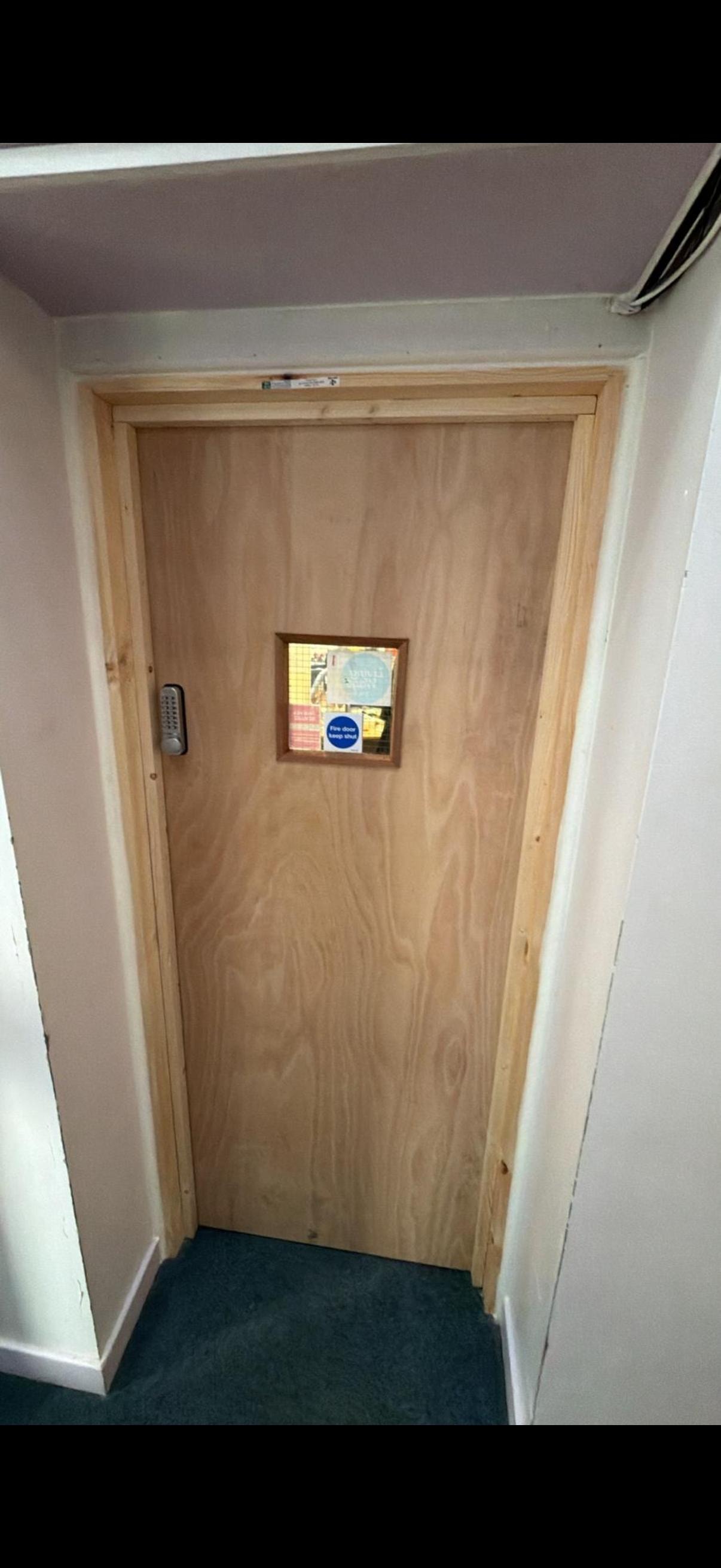 Wooden fire door with small window opening