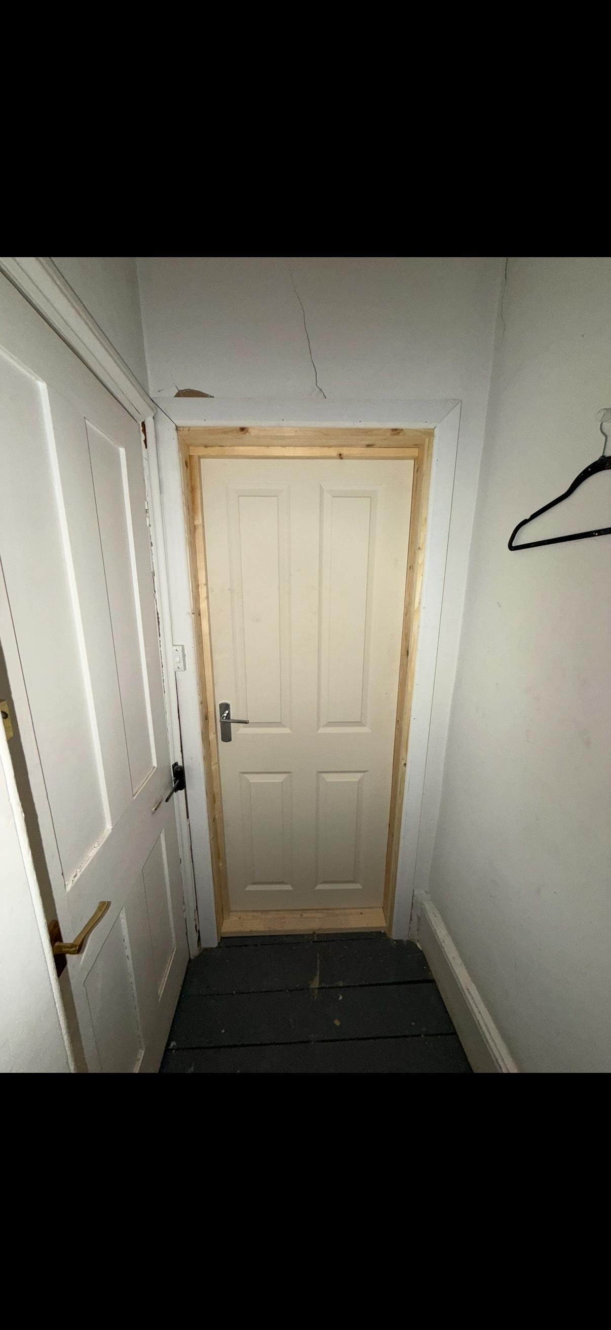 Narrow hallway with white fire door frame