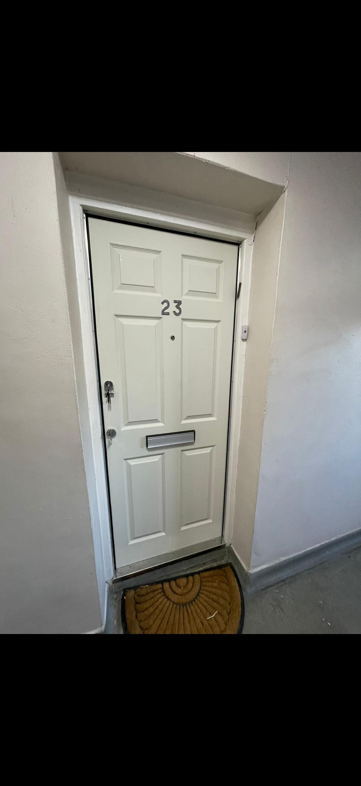 White apartment fire door number 23