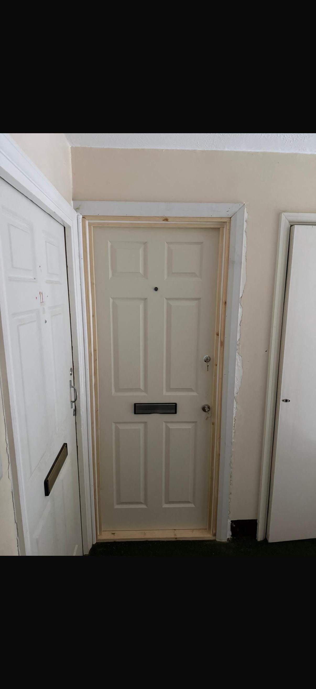 Cream coloured fire door with mail slot