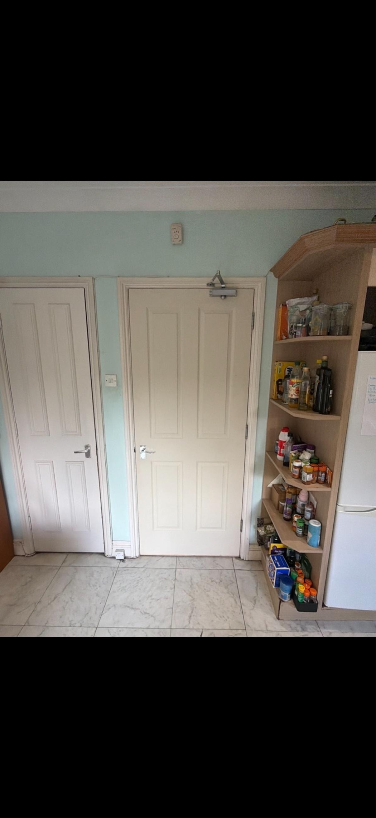 Kitchen with pantry shelving and white fire doors