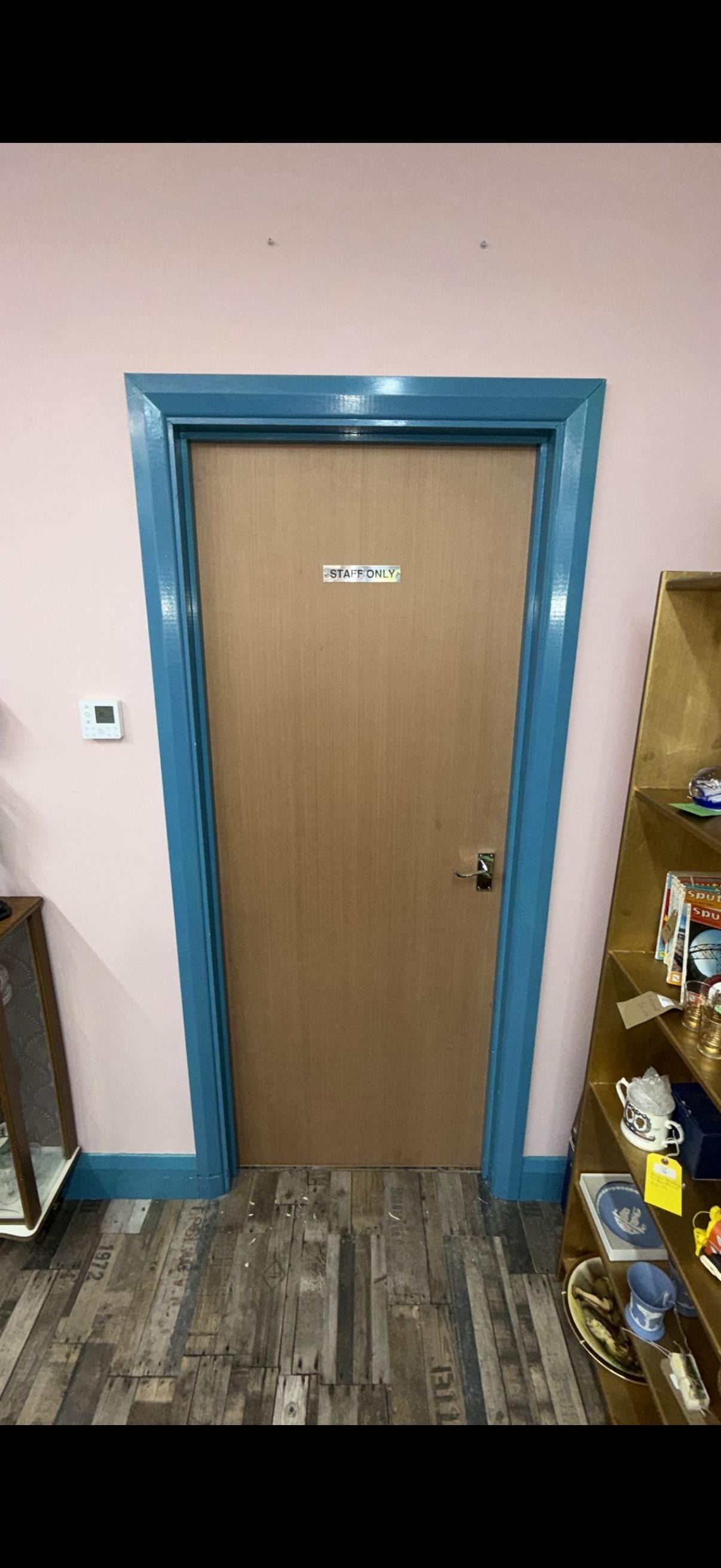 Blue framed fire door marked staff only