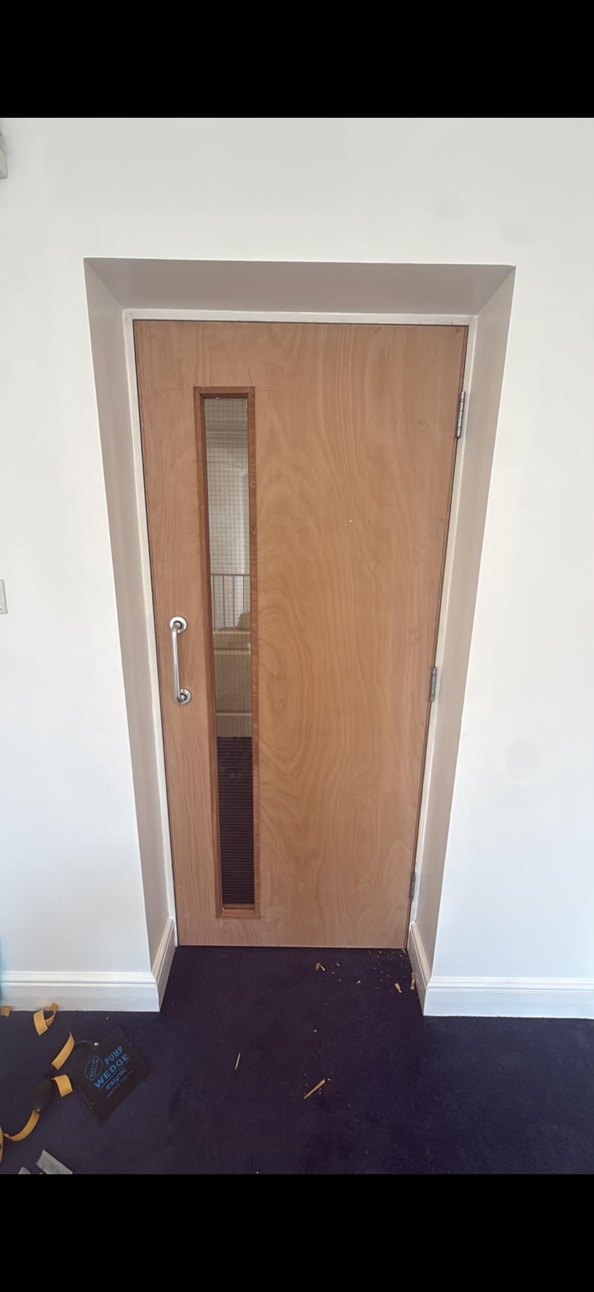 Wooden fire door with vertical window panel