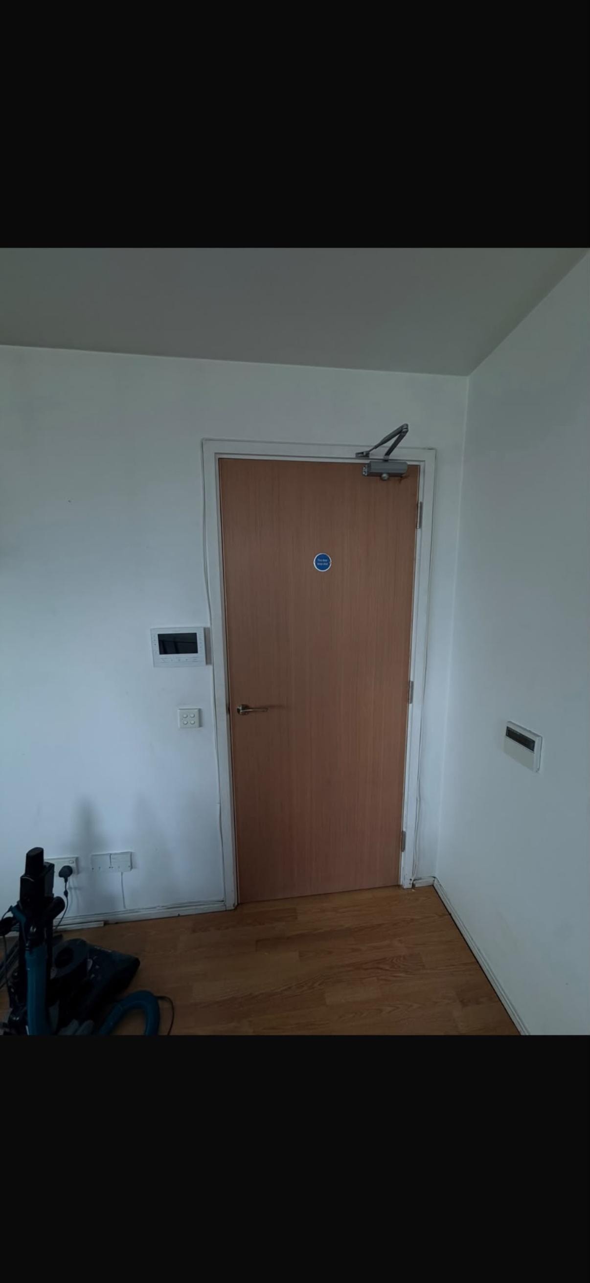 Modern apartment entryway with brown fire door